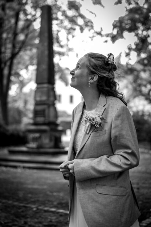 Braut schaut skeptisch zum regnerischen Himmel hinauf